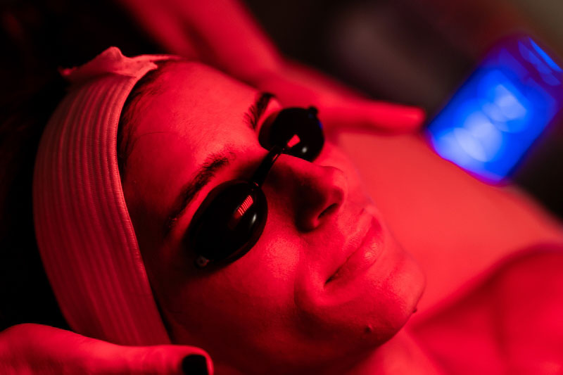 A woman receives an LED facial in a facial spa near Dallas, TX.