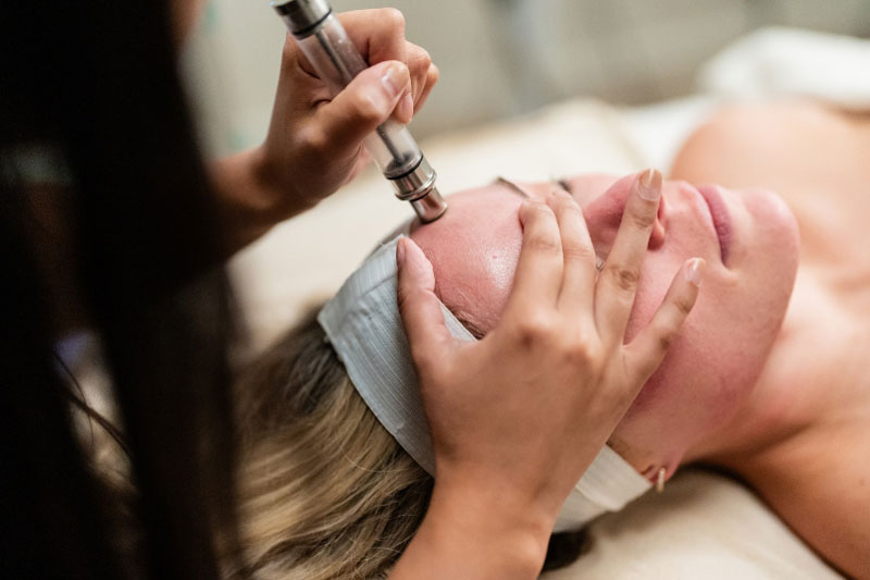 Close-up of a woman receiving Microdermabrasion at a facial spa near Northwest Dallas, TX.