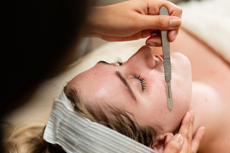 A woman receives dermaplaning treatment at a facial spa near Dallas, Texas.