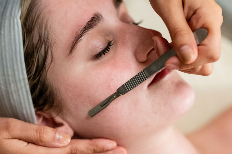 A woman undergoes dermaplaning as part of a custom facial at a spa in Flower Mound, TX.