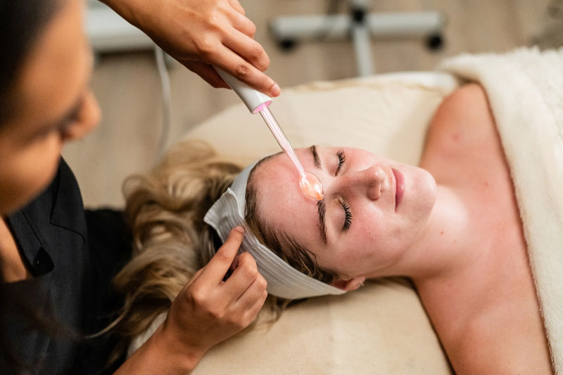 A woman gets a high frequency facial at a skincare spa near Northwest Dallas, Texas.