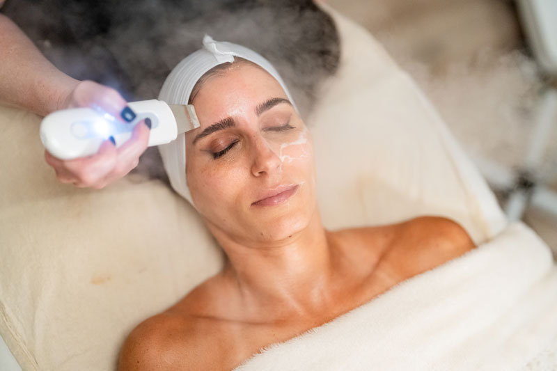 A woman receives an Ultrasonic Facial in a facial spa near Dallas, Texas.